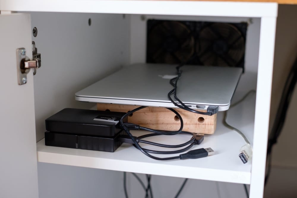 I glued some bits of wood together and stuck some rubber feet on to create a nice little stand. The big fans at the back do a really god job of keeping it cool.